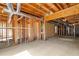 Unfinished basement with exposed wooden framework, concrete floor and visible utilities at 5831 Wembley Dr, Douglasville, GA 30135