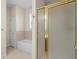 Bathroom with a tub and a glass and gold accented shower at 5831 Wembley Dr, Douglasville, GA 30135