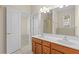 Bathroom with double sinks, a door to a bedroom, and a glass shower at 5831 Wembley Dr, Douglasville, GA 30135