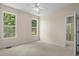 Neutral bedroom with two windows and an ensuite bath at 5831 Wembley Dr, Douglasville, GA 30135