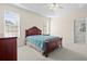 Relaxing bedroom with two windows, a ceiling fan and neutral-toned walls at 5831 Wembley Dr, Douglasville, GA 30135