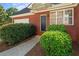 Charming brick home featuring a black front door and neat shrubbery at 5831 Wembley Dr, Douglasville, GA 30135