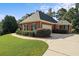 Well-maintained brick home with an attached garage, manicured landscaping, and a long driveway at 5831 Wembley Dr, Douglasville, GA 30135