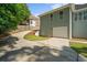 A spacious driveway leads to a two-car garage, complemented by lush landscaping and mature trees at 5831 Wembley Dr, Douglasville, GA 30135