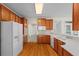 Open kitchen with wooden floors and an oversized white refrigerator at 5831 Wembley Dr, Douglasville, GA 30135
