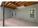 An outdoor patio features a concrete floor and wood beam ceiling, blending indoor comfort with outdoor enjoyment at 5831 Wembley Dr, Douglasville, GA 30135