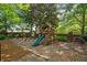 A colorful playground with swings and a slide provides a safe and fun area for to play and explore at 5831 Wembley Dr, Douglasville, GA 30135