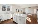 Modern kitchen featuring stainless steel appliances, island with white countertop, and wood floors at 5997 Creek Indian Dr, Sugar Hill, GA 30518