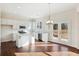 Charming kitchen with white cabinets, stainless steel appliances, and access to the backyard at 5997 Creek Indian Dr, Sugar Hill, GA 30518