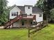 View of the back of the house, showing the back deck, walkout basement, and partially fenced yard at 6280 Autry Mill Rd, Cumming, GA 30028