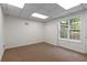 Unfinished basement space with carpet, drop ceiling, and natural light from the window at 6280 Autry Mill Rd, Cumming, GA 30028