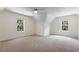 Bright bedroom with neutral carpet, ceiling fan, and natural light from the windows at 6280 Autry Mill Rd, Cumming, GA 30028