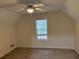 Bedroom with neutral carpet, ceiling fan, one window, and sloped ceilings at 6280 Autry Mill Rd, Cumming, GA 30028