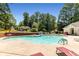 A community pool with chairs and lush trees at 6280 Autry Mill Rd, Cumming, GA 30028