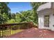 Wooden deck with stairs, railing, and door that leads to the interior of the house at 6280 Autry Mill Rd, Cumming, GA 30028