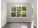 Bright dining area with large windows, stylish chandelier, and access to deck at 6280 Autry Mill Rd, Cumming, GA 30028