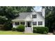 Charming white two-story home with a welcoming front porch and well-manicured landscaping at 6280 Autry Mill Rd, Cumming, GA 30028