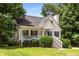 Attractive home with a front porch and well-kept lawn, surrounded by lush greenery at 6280 Autry Mill Rd, Cumming, GA 30028