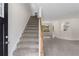 Inviting entry featuring a staircase, neutral carpeting, and lots of natural light at 6280 Autry Mill Rd, Cumming, GA 30028