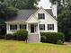 Charming two-story home with white siding, black shutters, a well-manicured lawn, and inviting front porch at 6280 Autry Mill Rd, Cumming, GA 30028