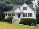 Charming two-story home with white siding, black shutters, a well-manicured lawn, and inviting front porch at 6280 Autry Mill Rd, Cumming, GA 30028