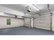 Spacious two car garage with painted floor, a window, and two garage doors at 6280 Autry Mill Rd, Cumming, GA 30028