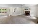 Cozy living room with fireplace, neutral carpet, and natural light at 6280 Autry Mill Rd, Cumming, GA 30028