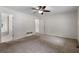 Spacious main bedroom with a ceiling fan and an attached bathroom at 6280 Autry Mill Rd, Cumming, GA 30028