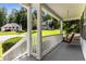 Inviting front porch with a cozy swing, perfect for relaxing and enjoying the view at 6280 Autry Mill Rd, Cumming, GA 30028