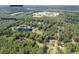 Aerial view of a community near schools with tree coverage and neighborhood streets at 6441 Michell Way, Douglasville, GA 30135