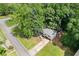 Aerial view of a charming house surrounded by lush greenery and a paved driveway at 6441 Michell Way, Douglasville, GA 30135