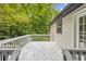 View of the back of the house featuring a small deck and wooded backyard at 6441 Michell Way, Douglasville, GA 30135