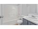 Bathroom featuring a tub with shower, toilet, and vanity sink with modern fixtures at 6441 Michell Way, Douglasville, GA 30135