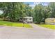 Charming home featuring a welcoming porch, two car garage and mature trees at 6441 Michell Way, Douglasville, GA 30135
