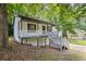 Exterior view of home featuring welcoming porch and mature trees at 6441 Michell Way, Douglasville, GA 30135