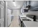 Galley kitchen with gray cabinets, white countertops, and black appliances at 6441 Michell Way, Douglasville, GA 30135