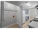 Galley kitchen with gray cabinets, white countertops, and an attached laundry area at 6441 Michell Way, Douglasville, GA 30135