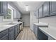Galley kitchen with gray cabinets and a window to bring in natural light at 6441 Michell Way, Douglasville, GA 30135