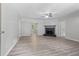 Bright living room with a ceiling fan, fireplace, and wood-look floors at 6441 Michell Way, Douglasville, GA 30135