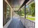 View of the home's covered porch, with white railing and grey decking at 6441 Michell Way, Douglasville, GA 30135