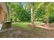 A spacious backyard features lush greenery and mature trees, offering a serene outdoor space at 6671 Gano Dr, Riverdale, GA 30274