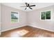 Bedroom with hardwood floors, two windows and a ceiling fan at 6671 Gano Dr, Riverdale, GA 30274