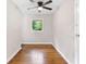 Cozy bedroom featuring hardwood floors, neutral paint, a ceiling fan and window with natural light at 6671 Gano Dr, Riverdale, GA 30274