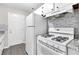Kitchen featuring white cabinets, gray granite countertops and white gas range at 6671 Gano Dr, Riverdale, GA 30274