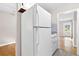 View of a kitchen with white appliances, including a white refrigerator and gas burning range at 6671 Gano Dr, Riverdale, GA 30274