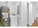 Laundry area with a new hot water tank and a washer and dryer at 6671 Gano Dr, Riverdale, GA 30274