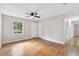 Spacious living room with hardwood floors, ceiling fan, natural light, and view into hallway at 6671 Gano Dr, Riverdale, GA 30274