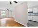 Open living area with hardwood floors that provides a view into the kitchen with white cabinets at 6671 Gano Dr, Riverdale, GA 30274