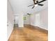 Open living room featuring gleaming hardwood floors, neutral paint and multiple ceiling fans at 6671 Gano Dr, Riverdale, GA 30274