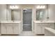 Modern bathroom featuring double vanity sinks, white cabinets, and a doorway leading into a bedroom at 1858 Belmore Se St, Smyrna, GA 30080